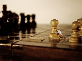Man-pushing-a-chess-figure-The-journey-of-a-thousand-miles-begins-with-a-single-step.