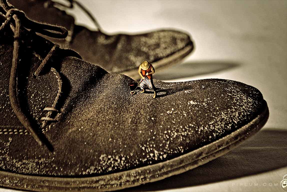 Surreal photography. Man at work. Man-cleaning-shoes-Surreal-photography