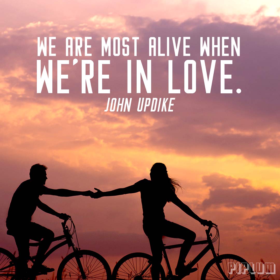 Love-quote-Man-and-women-holding-hands-while-riding-with-bikes-in-the-sunset