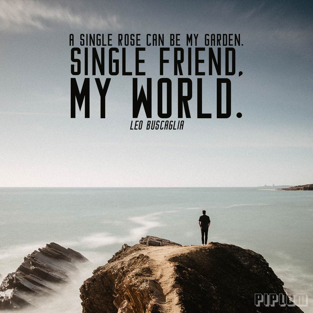 Friendship quote. Man standing alone on the rock and facing the wast ocean.