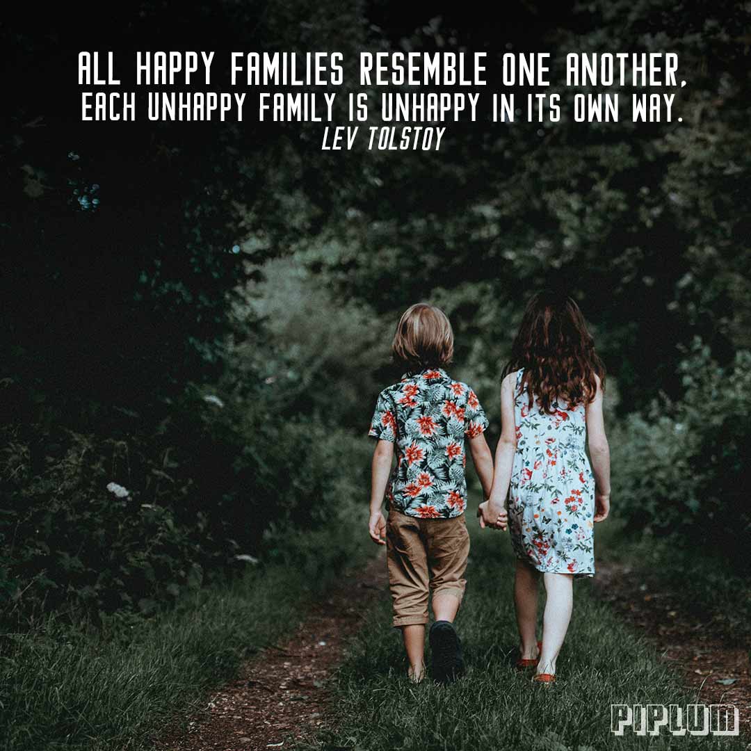 Family Quote. Brother and sister holding hands in the forest.