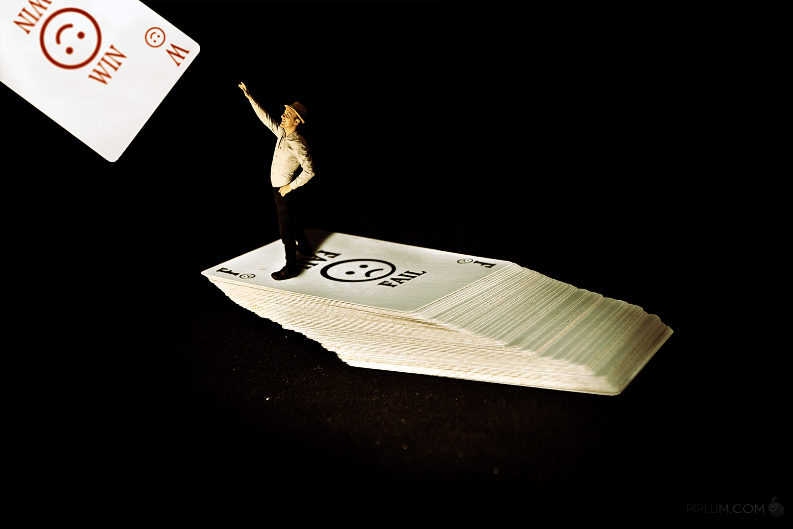 Motivational-Quote-Man-trying-to-pick-a-lucky-card-after-many-fails-surreal-miniature-photography-photo-manipulation