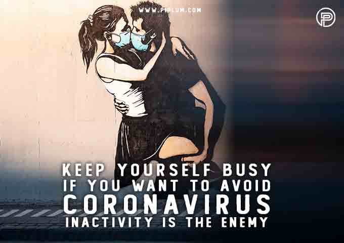 couple-kissing-with-the-masks-on-wall-painting-words-Inactivity-is-the-enemy