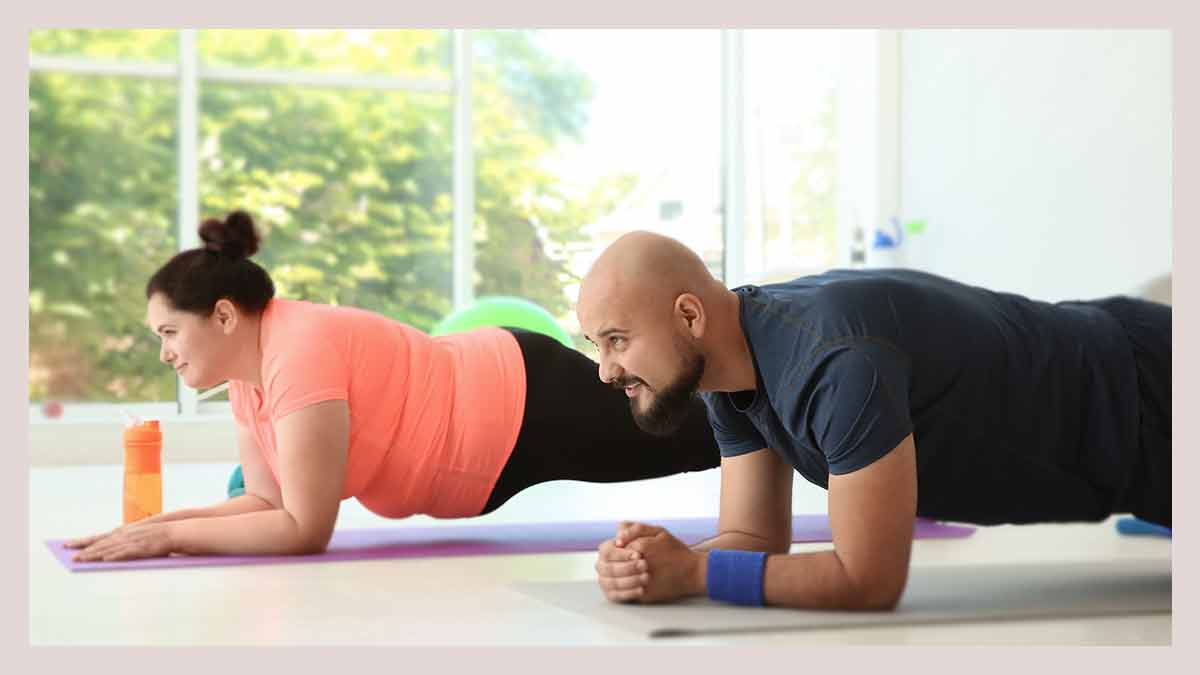 husband-and-wife-doing-free-workout-program-exercise-plank-at-home-together
